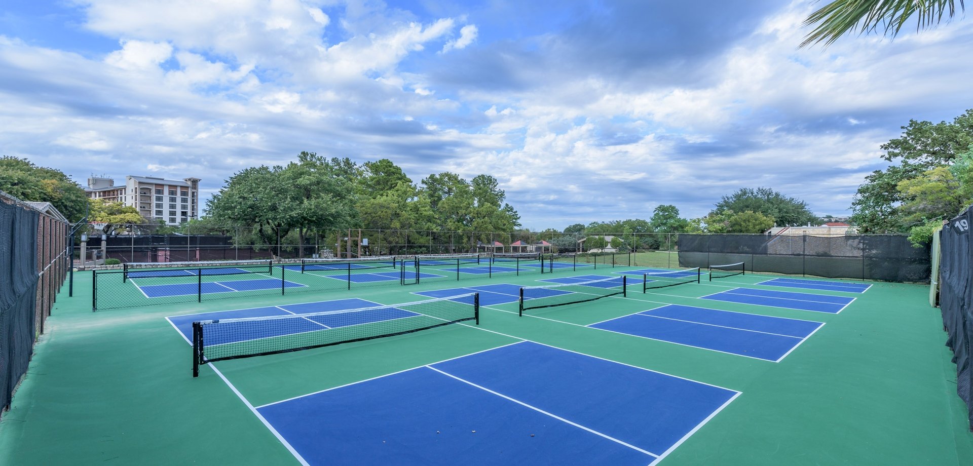 8 pickleball courts with green and blue paint.