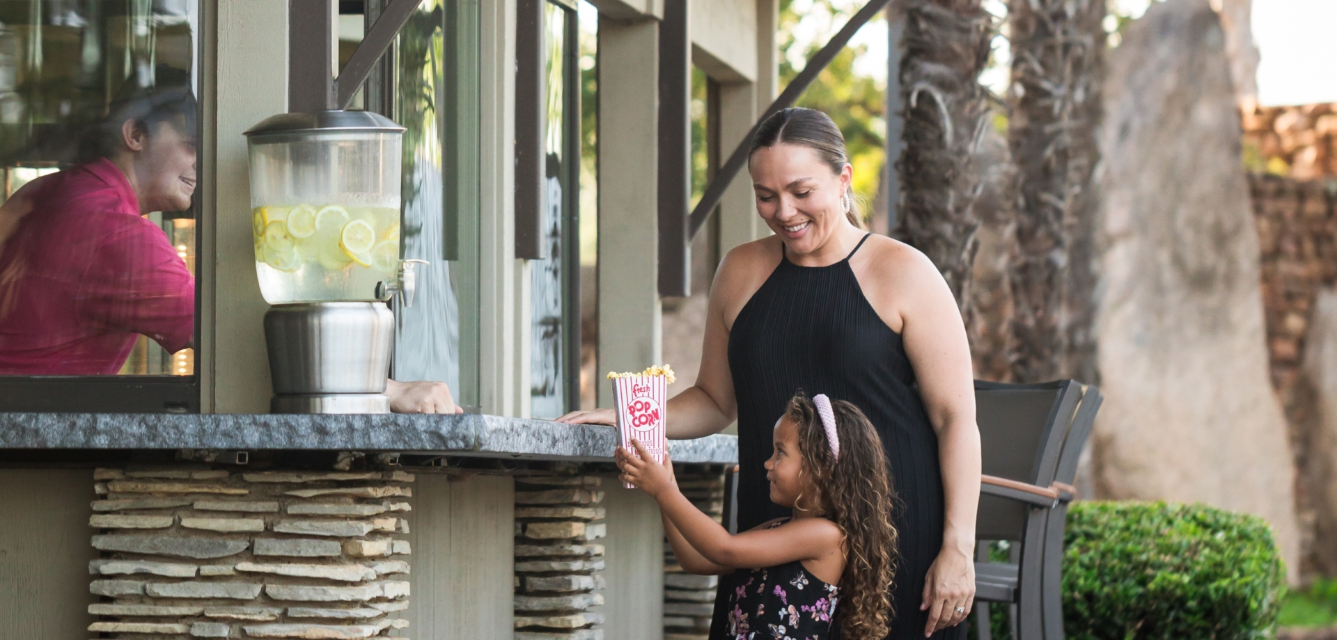 A mother and daughter getting popcorn from Mingo's Cafe at Horseshoe Bay Resort