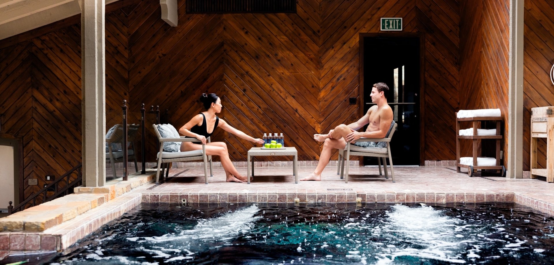 Couple sitting poolside